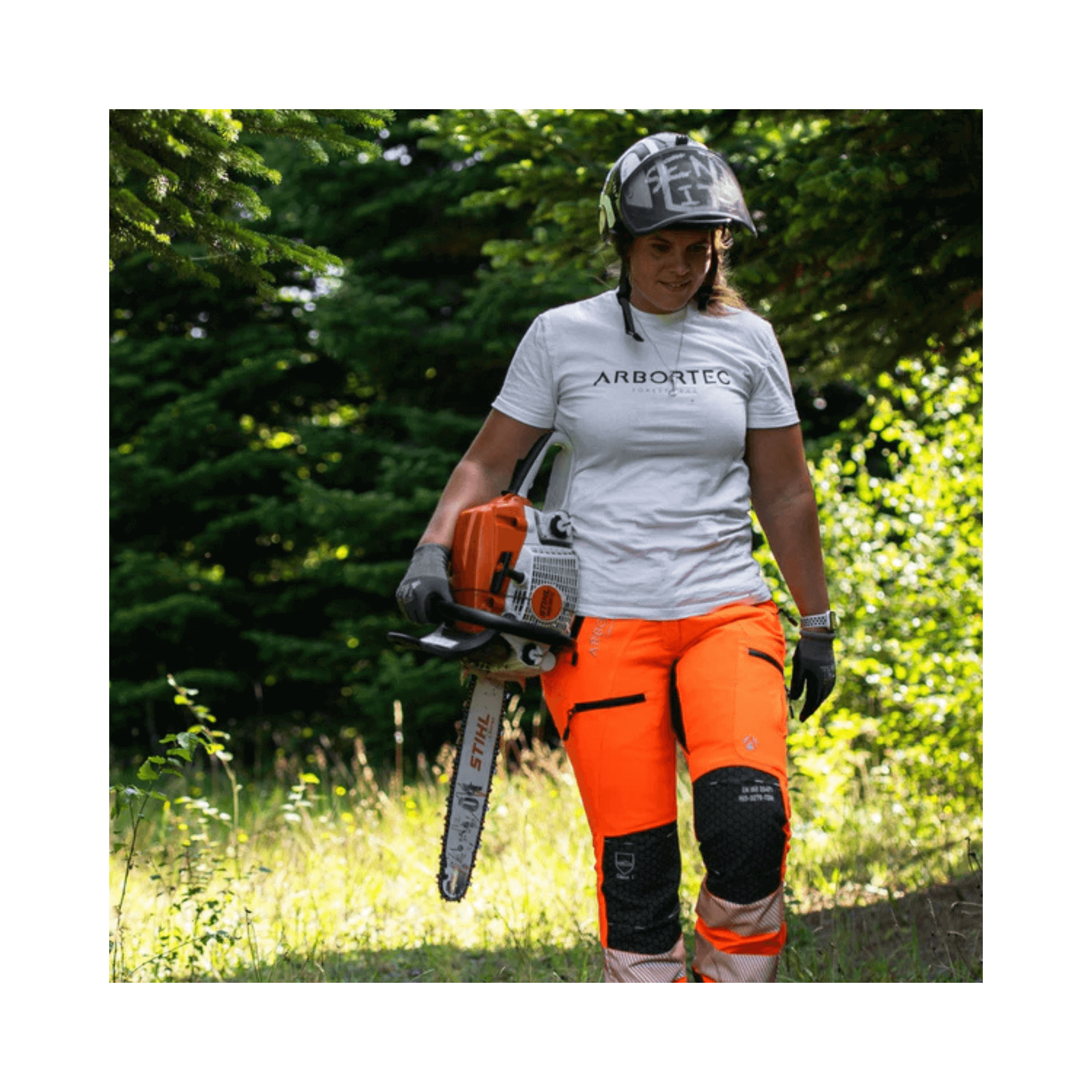 Breatheflex Pro Womens Chainsaw Trousers Type A Hi-Vis Orange on a woman using a chainsaw in the forest.