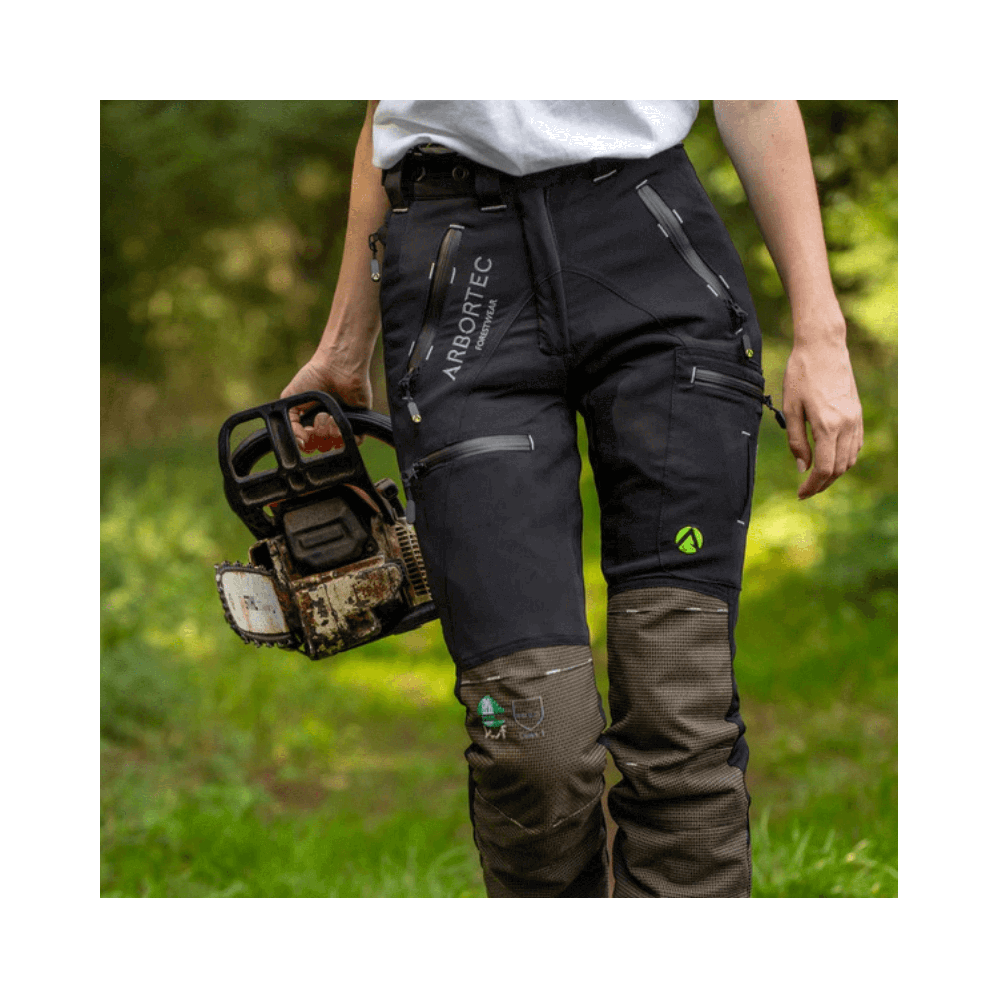 Breatheflex Pro Womens Chainsaw Trousers Type C Black worn by female arborist holding chainsaw in forest.