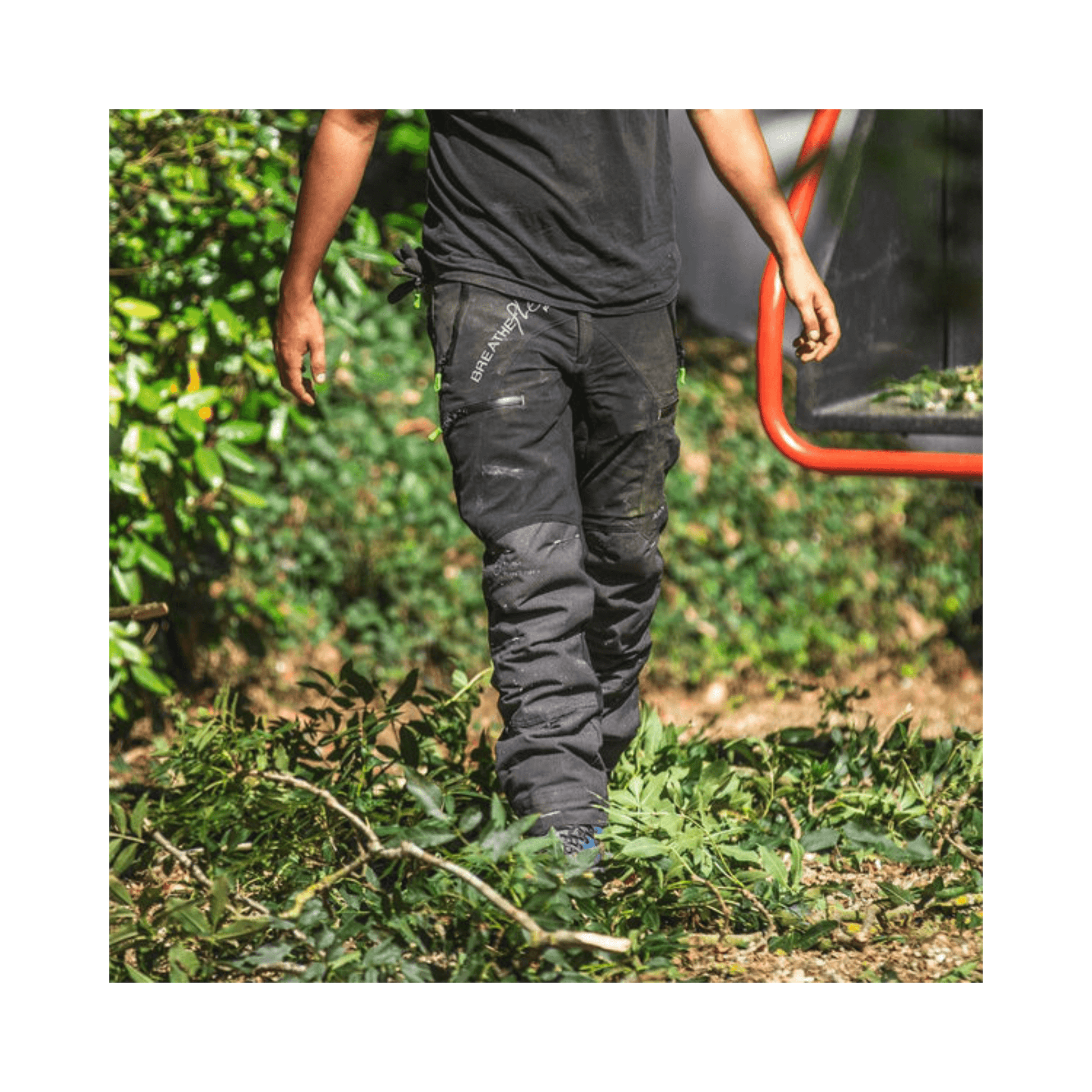 Breatheflex Pro Chainsaw Trousers Black Type C worn by a tree surgeon among green foliage.