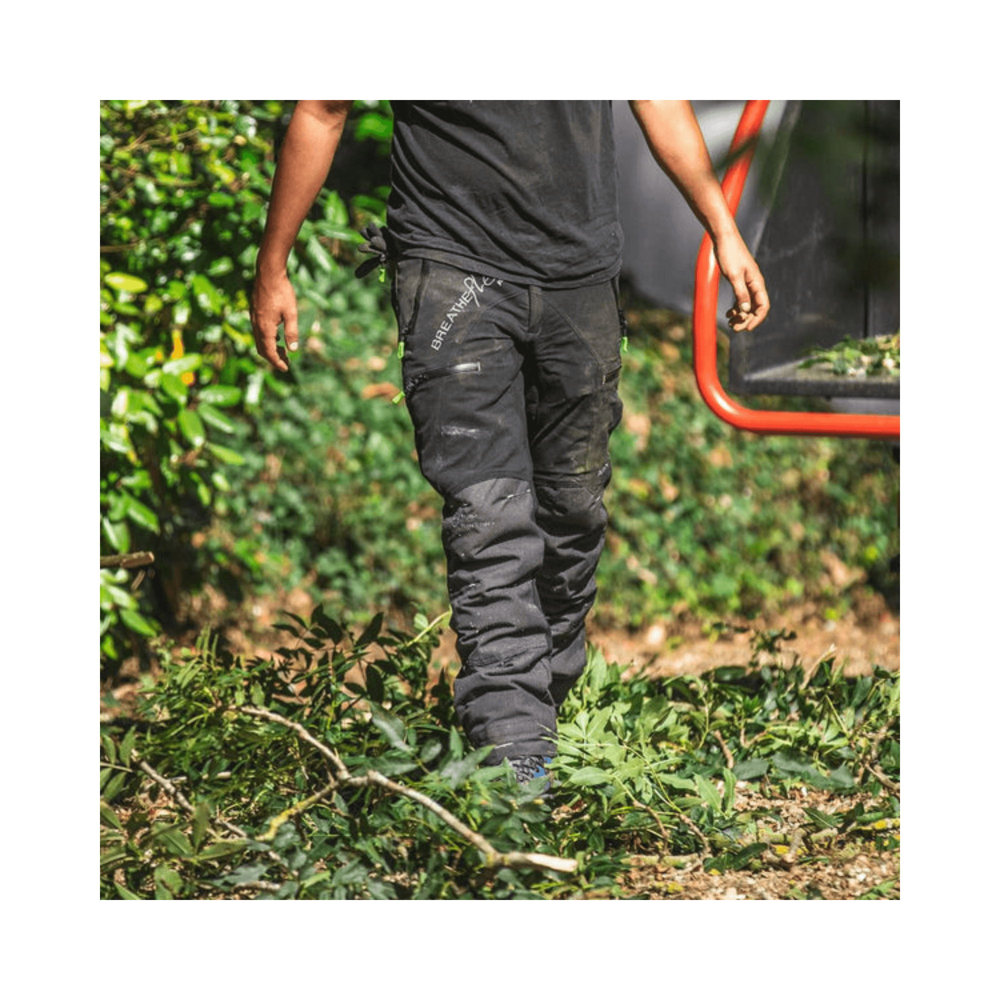 Breatheflex Pro Chainsaw Trousers Black Type C worn by a tree surgeon among green foliage.