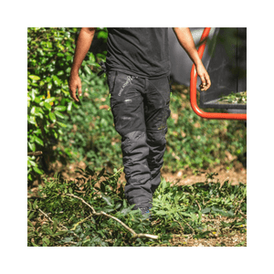 Breatheflex Pro Chainsaw Trousers Black Type C worn by a tree surgeon among green foliage.