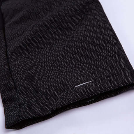 Close-up of Breatheflex Pro Freestyle Chainsaw Trousers, showcasing durable black fabric and hexagonal texture for tree surgeons.