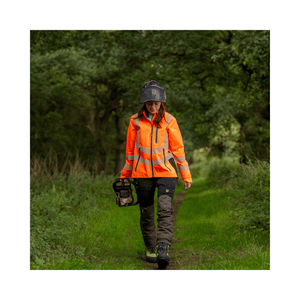Full Zip Waterproof Womens Work Jacket Hi-Vis Orange worn by a woman walking in a green outdoor setting.