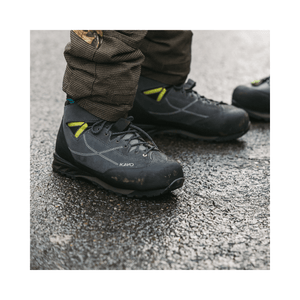 Kayo Chainsaw Boots Class 2 worn by a tree surgeon on a wet surface, showcasing protective features and modern design.