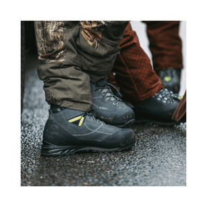 Kayo Chainsaw Boots Class 2 worn by tree surgeons on a wet surface during climbing work.
