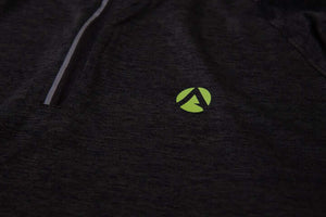 Close-up of black performance T-shirt with green Arbortec logo, designed for tree surgeons and active individuals.