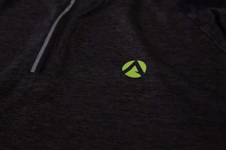 Close-up of black performance T-shirt with green Arbortec logo, designed for tree surgeons and active individuals.