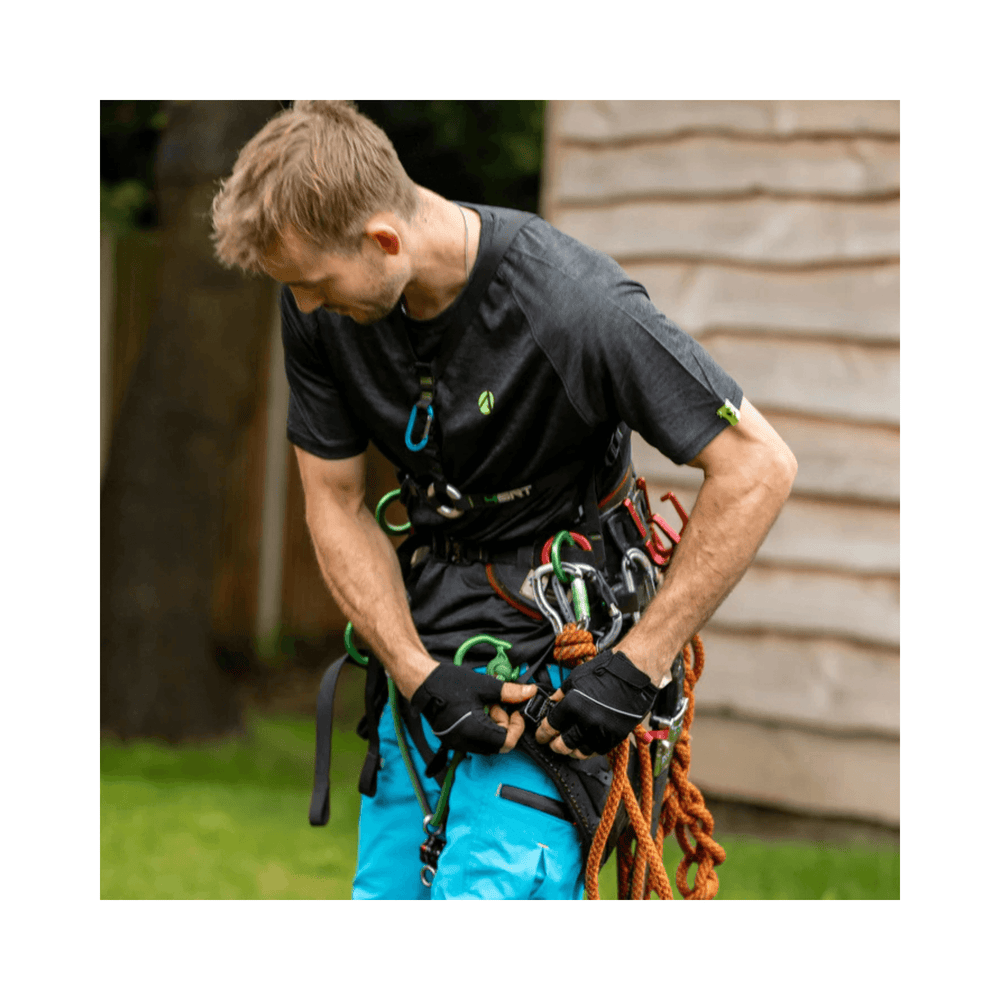 Man wearing Performance T-Shirt Short Sleeve while preparing climbing gear for tree surgery.