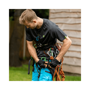 Man wearing Performance T-Shirt Short Sleeve while preparing climbing gear for tree surgery.