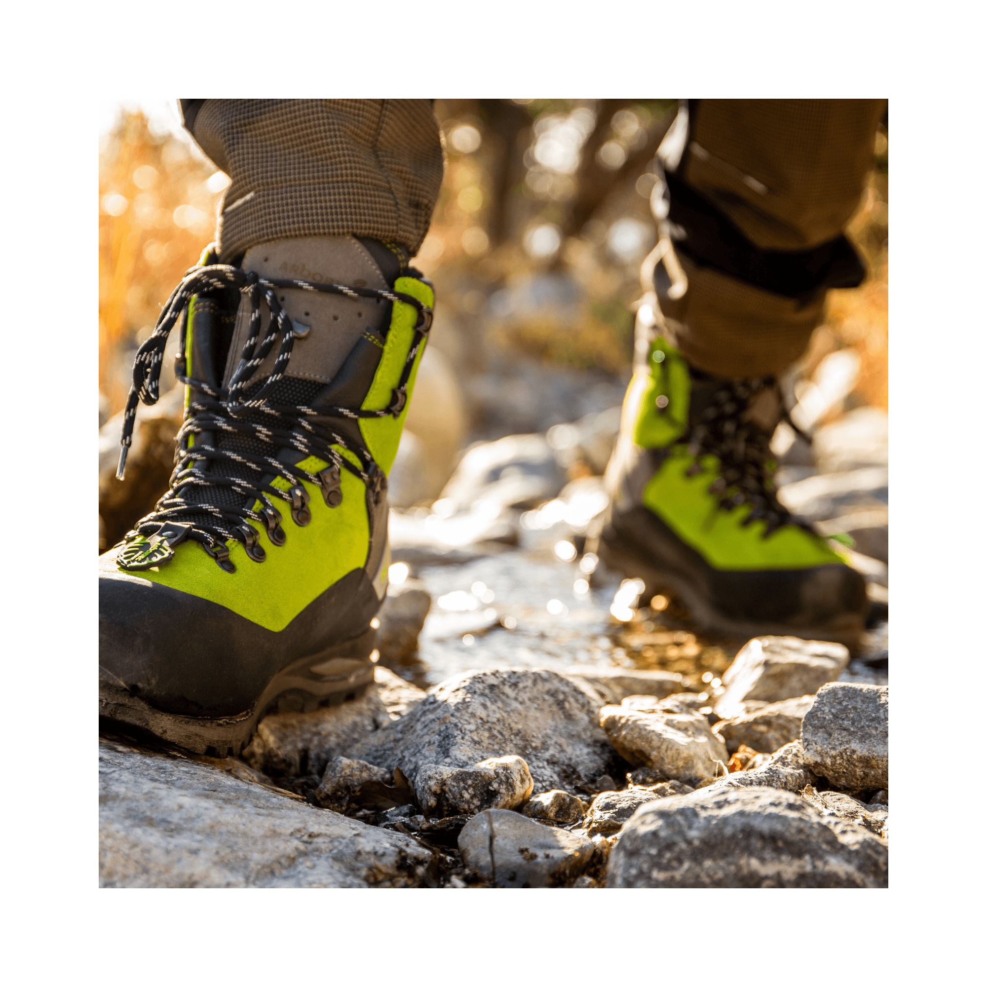 Scafell Lite Chainsaw Boots Class 2 worn by a tree surgeon on rocky terrain.