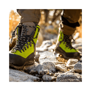 Scafell Lite Chainsaw Boots Class 2 worn by a tree surgeon on rocky terrain.