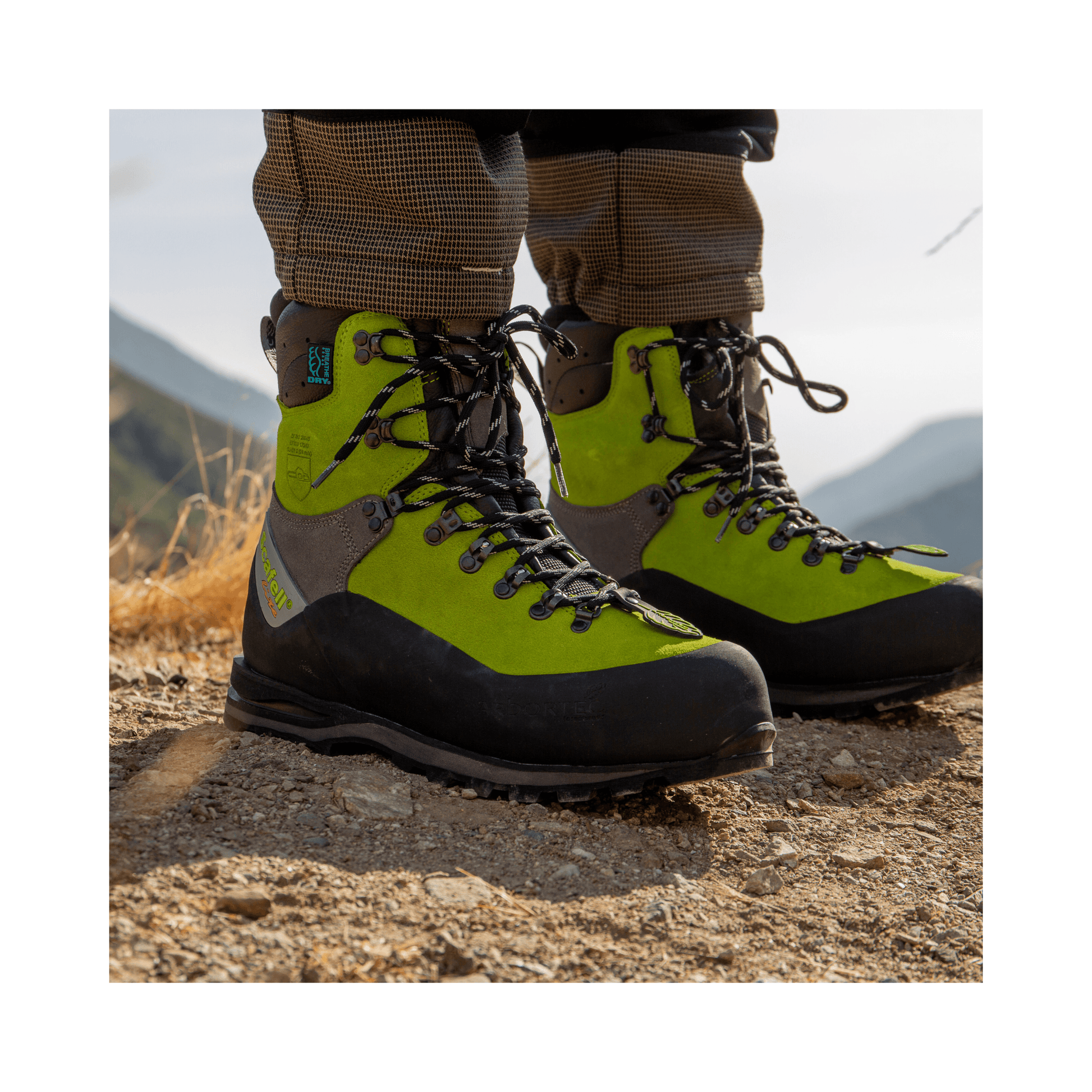 Scafell Lite Chainsaw Boots Class 2 showcased in rugged terrain for tree surgeons, emphasizing safety and durability.