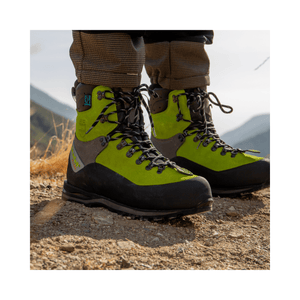 Scafell Lite Chainsaw Boots Class 2 showcased in rugged terrain for tree surgeons, emphasizing safety and durability.