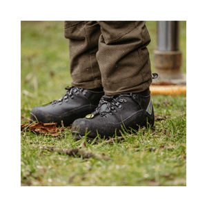 Scafell Lite Chainsaw Boots Class 2 worn by a tree surgeon in a forest setting on grass.