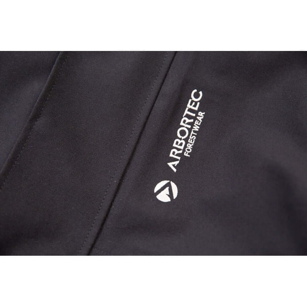 Close-up of Arbortec logo on a black heavy-duty jacket for tree surgeons, highlighting quality forestwear.