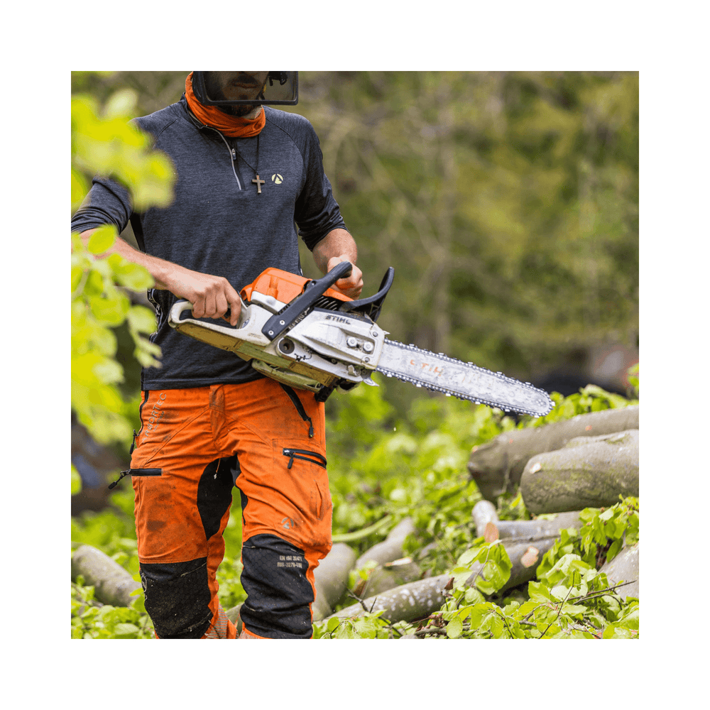 Tree surgeon wearing Arbortec Breatheflex Pro chainsaw trousers in Hi-Viz orange, using a chainsaw in a wooded area.