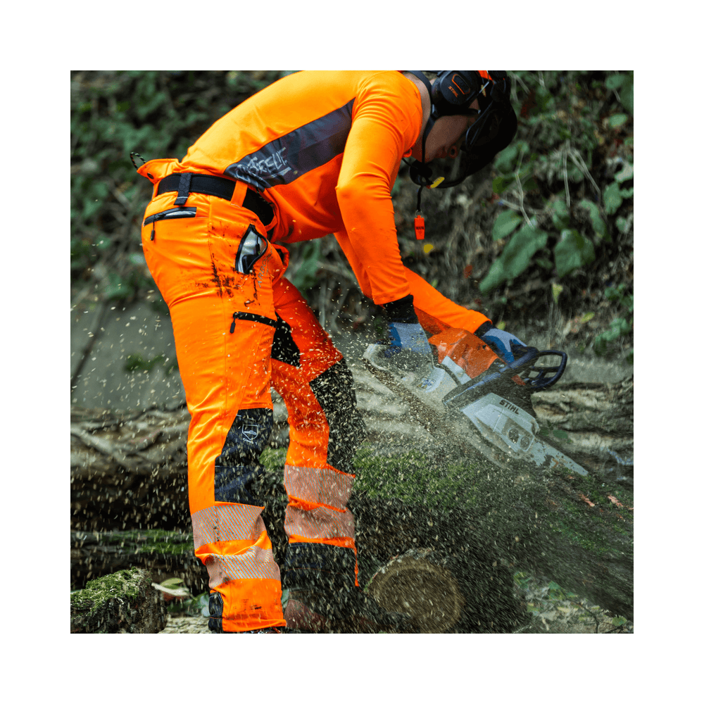 Tree surgeon in Hi-Viz orange Breatheflex Pro chainsaw trousers cutting wood with chainsaw.