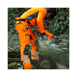 Tree surgeon in Hi-Viz orange Breatheflex Pro chainsaw trousers cutting wood with chainsaw.
