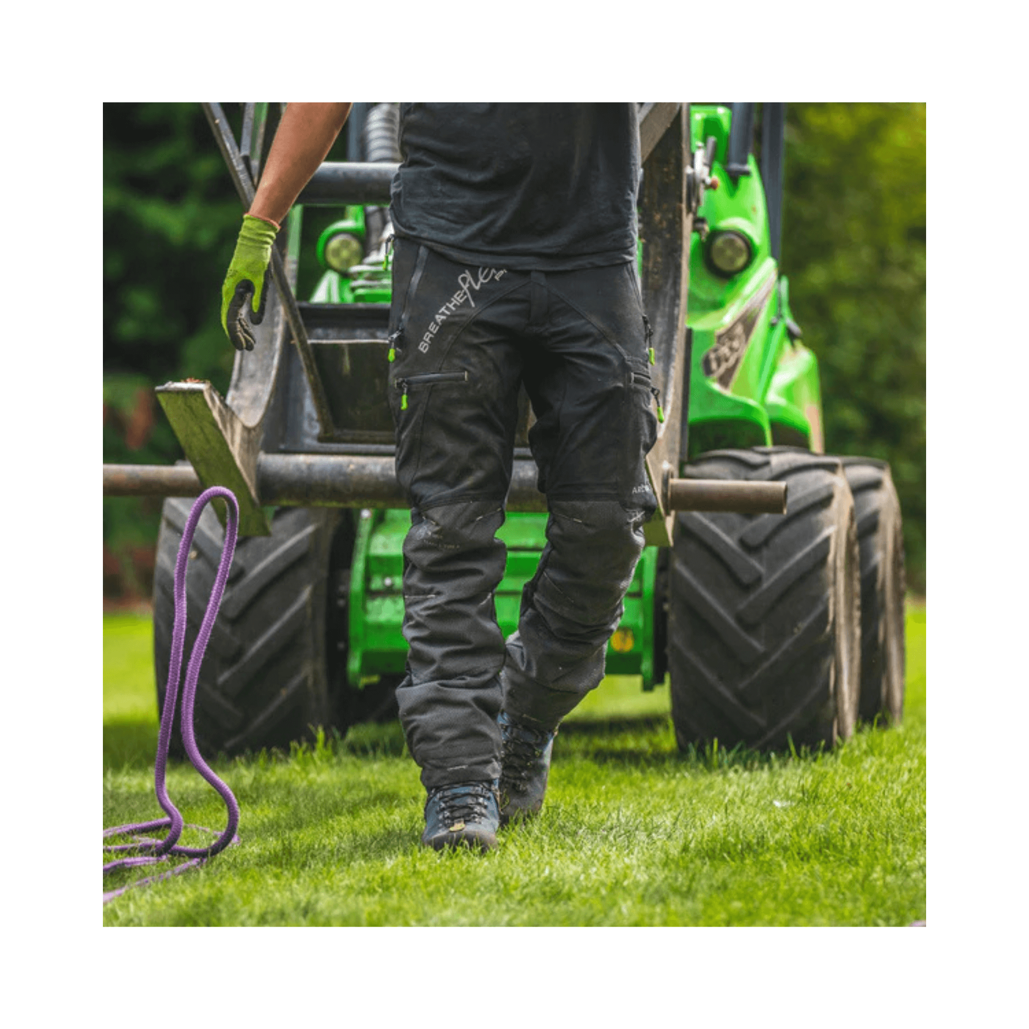 Professional tree surgeon wearing Arbortec Breatheflex Pro Black Chainsaw Trousers, working on site.