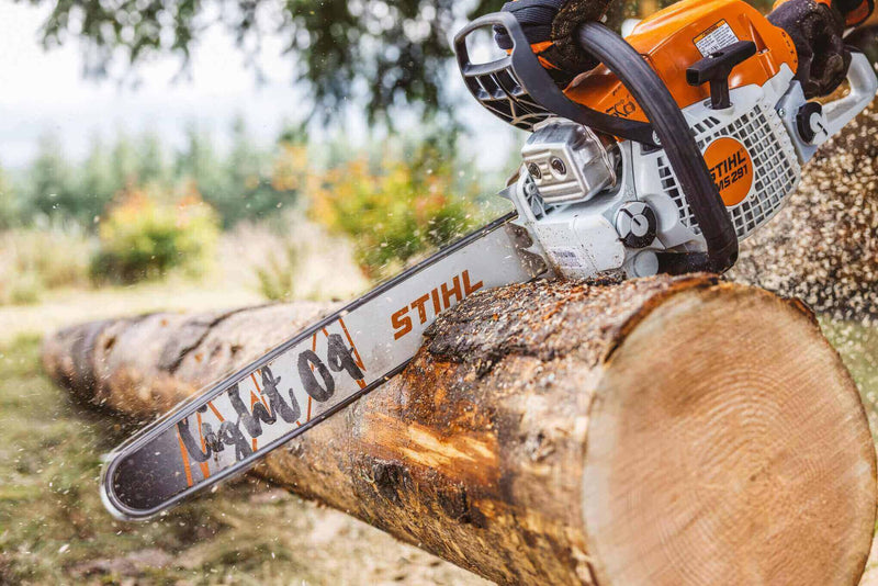 STIHL chainsaw cutting through a log, showcasing powerful performance in outdoor work.