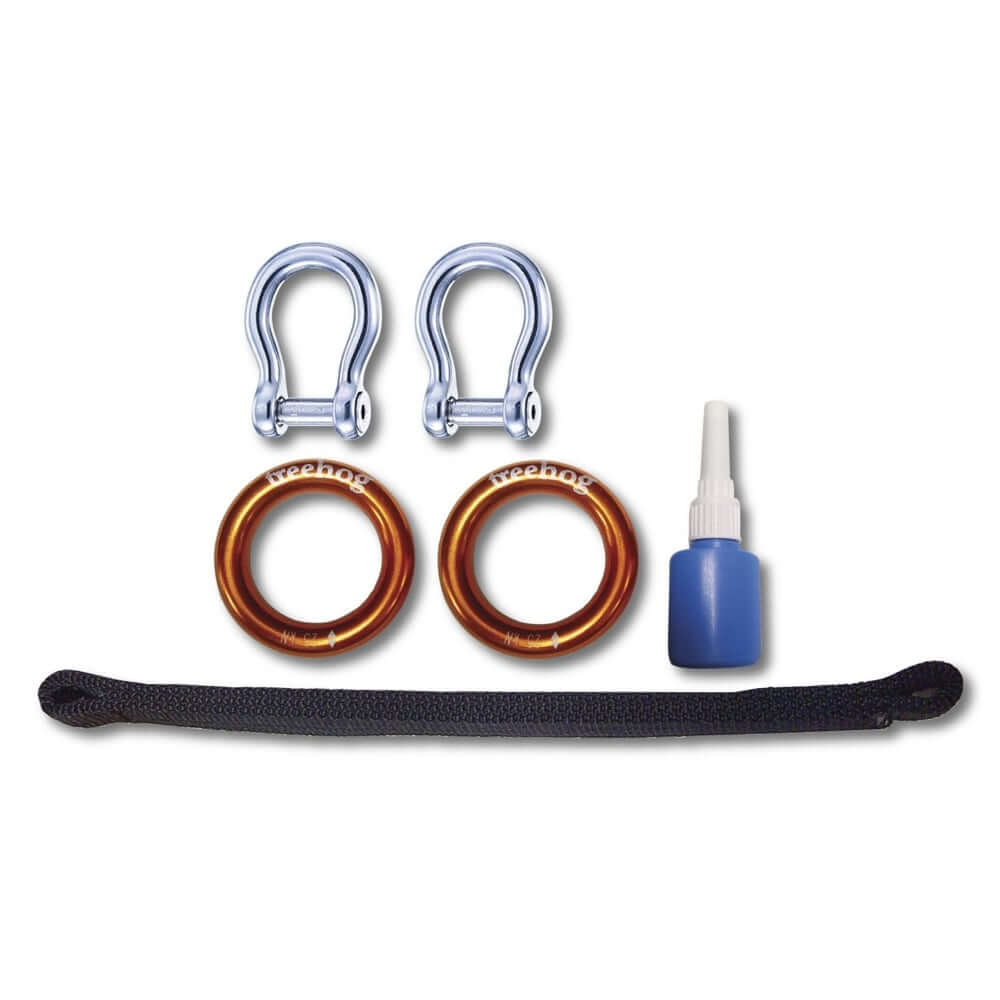 Spare bridge kit components for Treehog climbing harness including aluminum rings and adhesive.