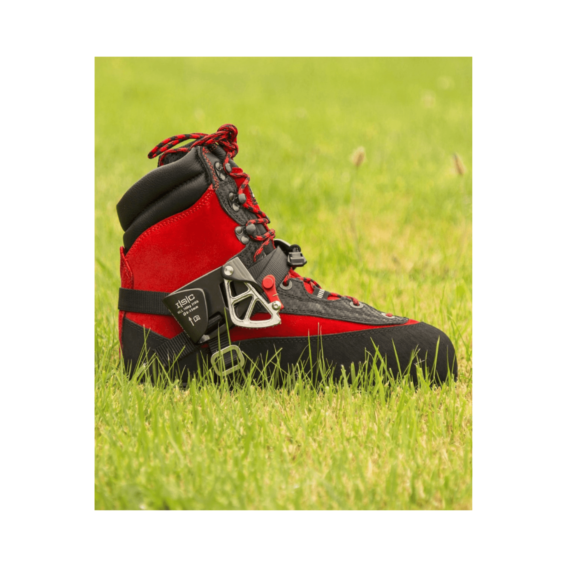 STRYDER Foot Ascender in vibrant red and black, placed on green grass, designed for climbing and rope access.