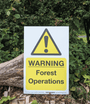 Warning sign for forest operations indicating safety precautions in tree surgeon activities.