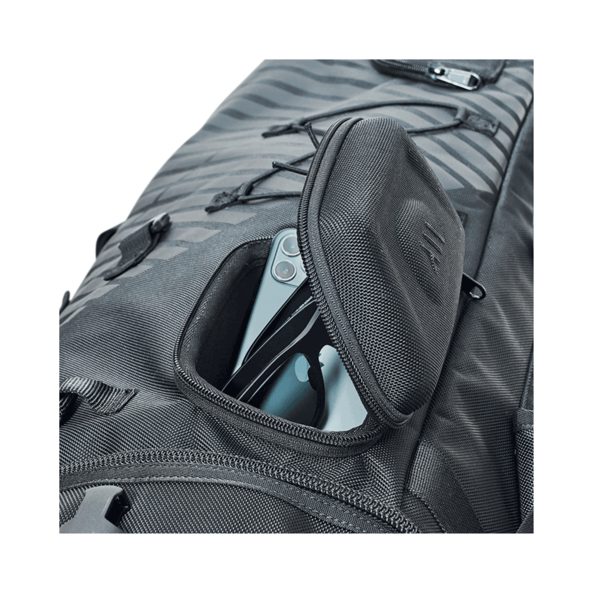 Close-up of Courant Cross Pro XL Rescue Bag All Black's pocket with smartphone visible.