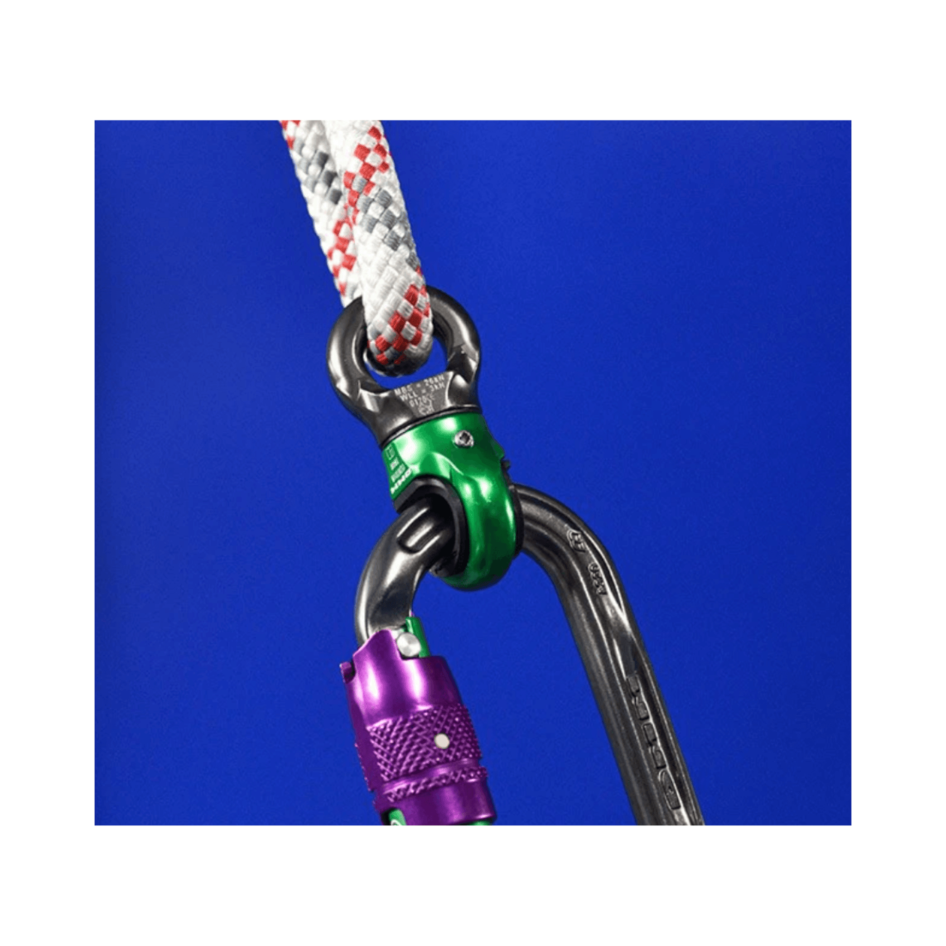 Close-up of DMM Mini Swivel connected to a carabiner and rope against a blue background.