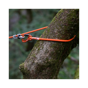 Nomad Friction Hitch Lanyard System secured to a tree with vibrant rope and gear for arborist work.