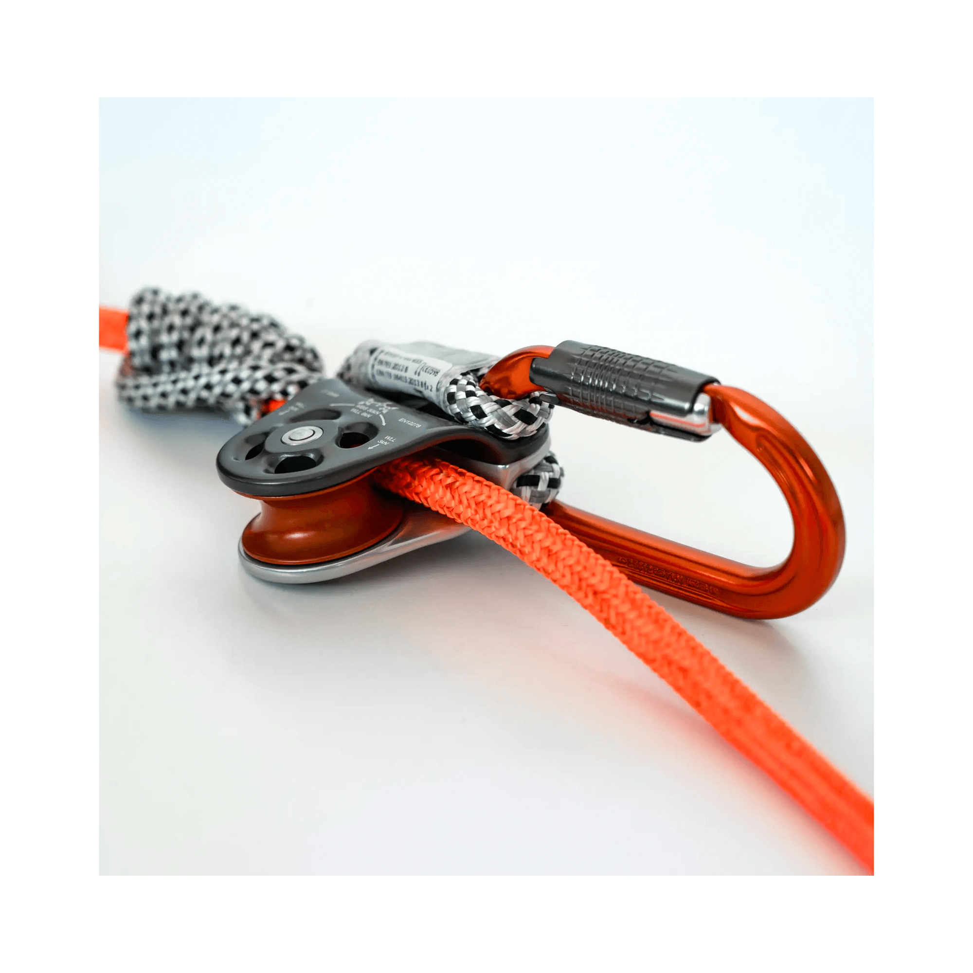 Nomad Friction Hitch Lanyard System featuring a carabiner, pulley, and vibrant orange rope for professional arborists.