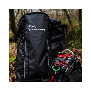 DMM Porter Rope Bag shown in a wet environment with climbing gear nearby, designed for heavy-duty use.
