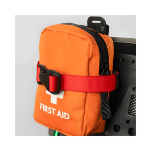 Caiman Harness Strap securing an orange first aid pouch for easy access and safety at height.