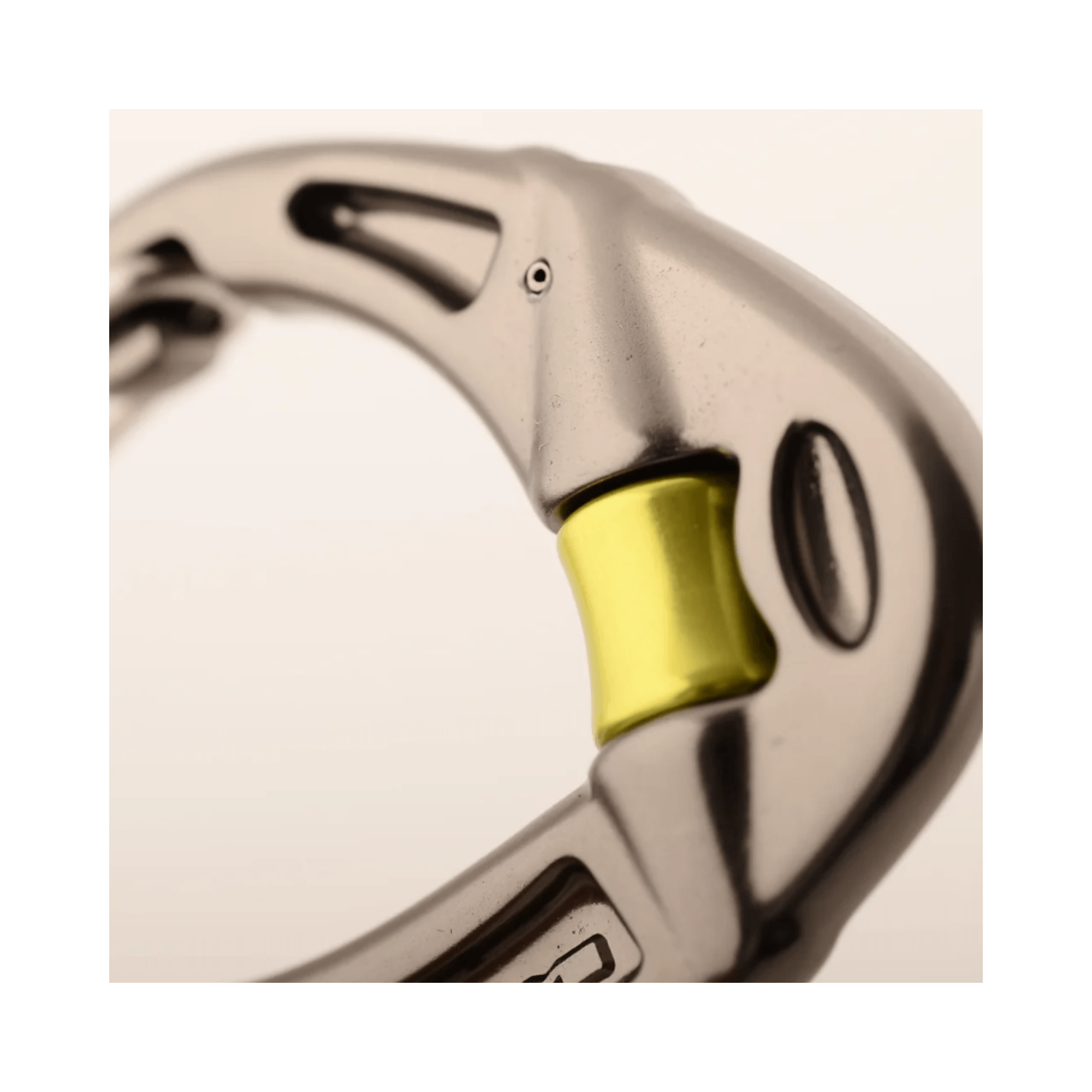 Close-up of the DMM Revolver Locksafe Carabiner featuring its unique locking mechanism.
