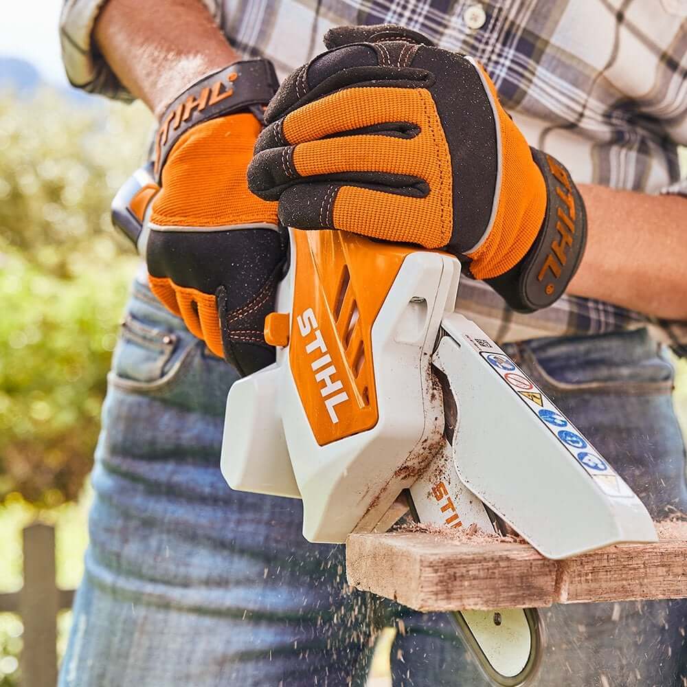 Person using STIHL GTA 26 cordless battery pruning saw for precision gardening tasks.