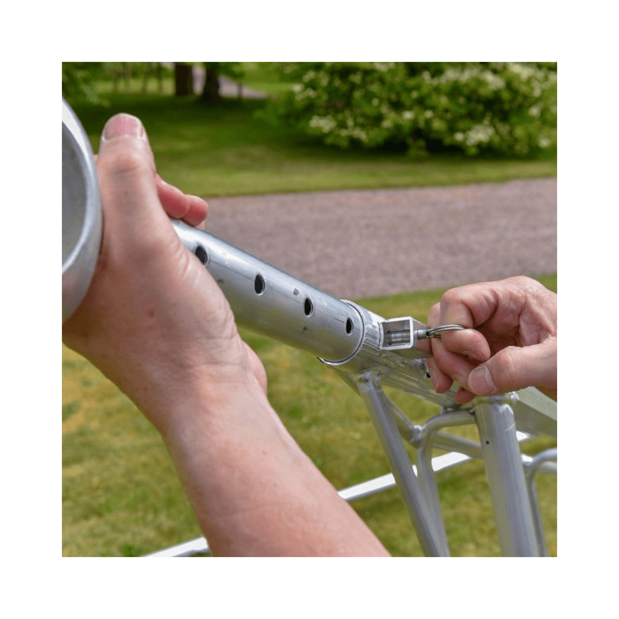 Hand securing a Spare Ring For Ladders on a ladder's locking mechanism for safety and stability.