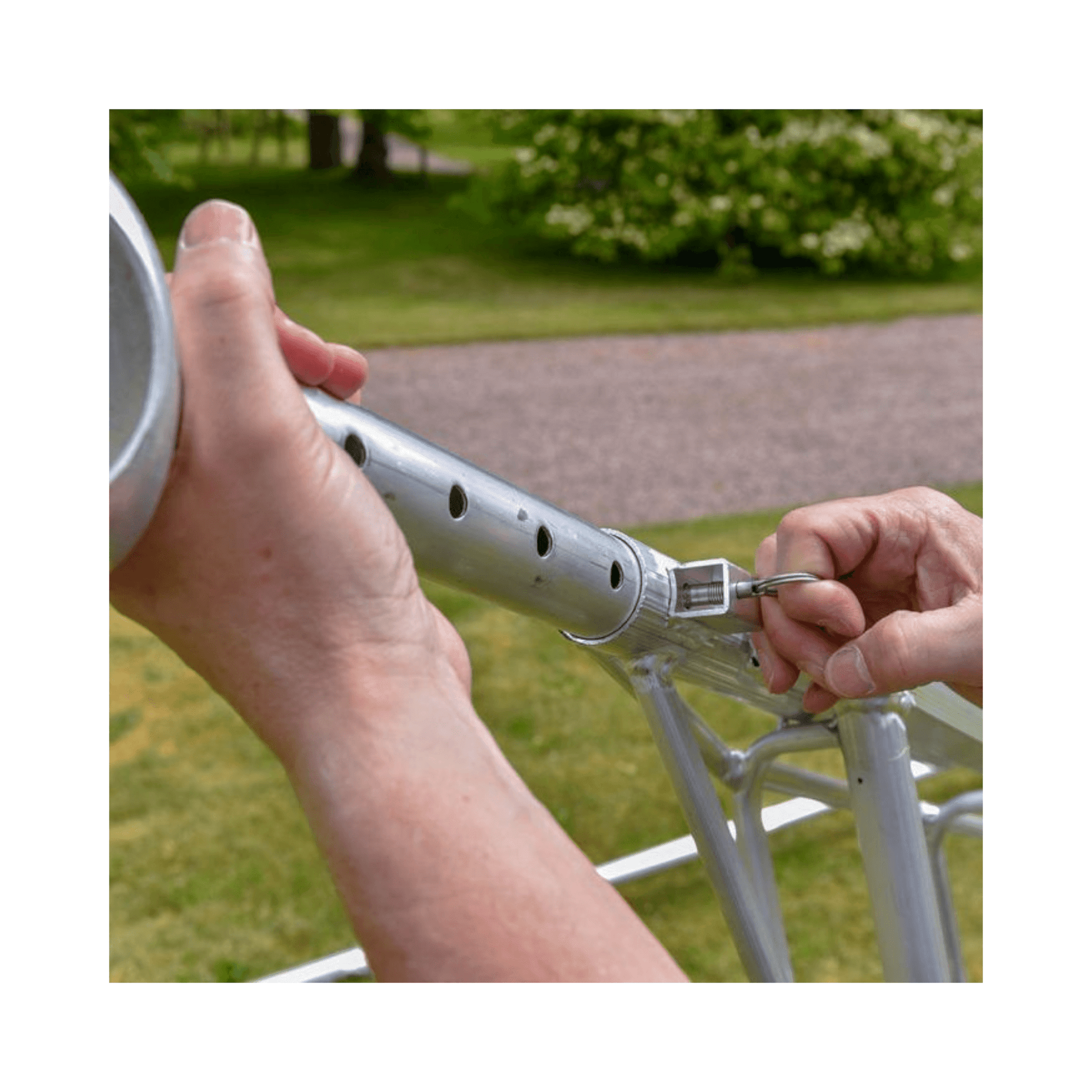 Hand securing a Spare Ring For Ladders on a ladder's locking mechanism for safety and stability.