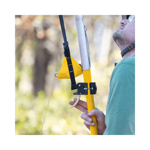 User operating the Notch Big Shot Trigger system on a fiberglass pole for tree climbing.