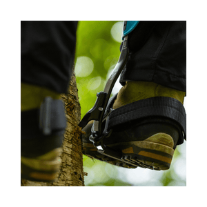 Close-up of Notch Equipment Steel Climbers in use by an arborist on a tree trunk.