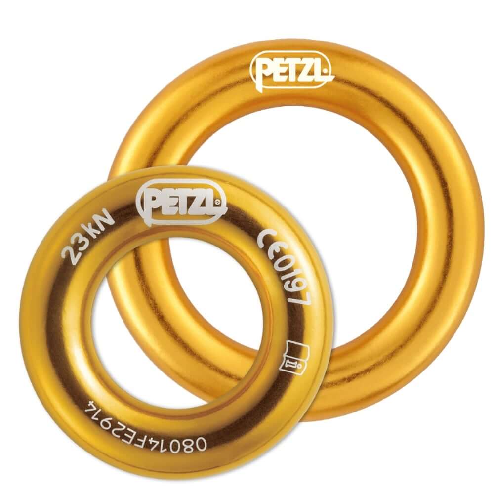 Two gold-colored Petzl connection rings, one larger and one smaller, designed for use in tree climbing equipment.