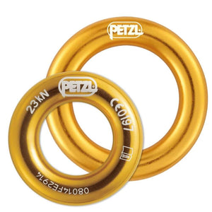 Two gold-colored Petzl connection rings, one larger and one smaller, designed for use in tree climbing equipment.