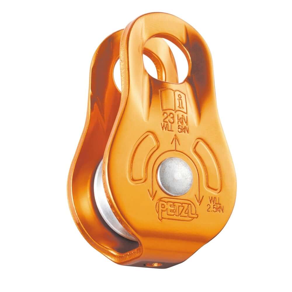 A compact orange Petzl FIXE pulley with aluminum side plates and sheave, designed for climbing equipment use.