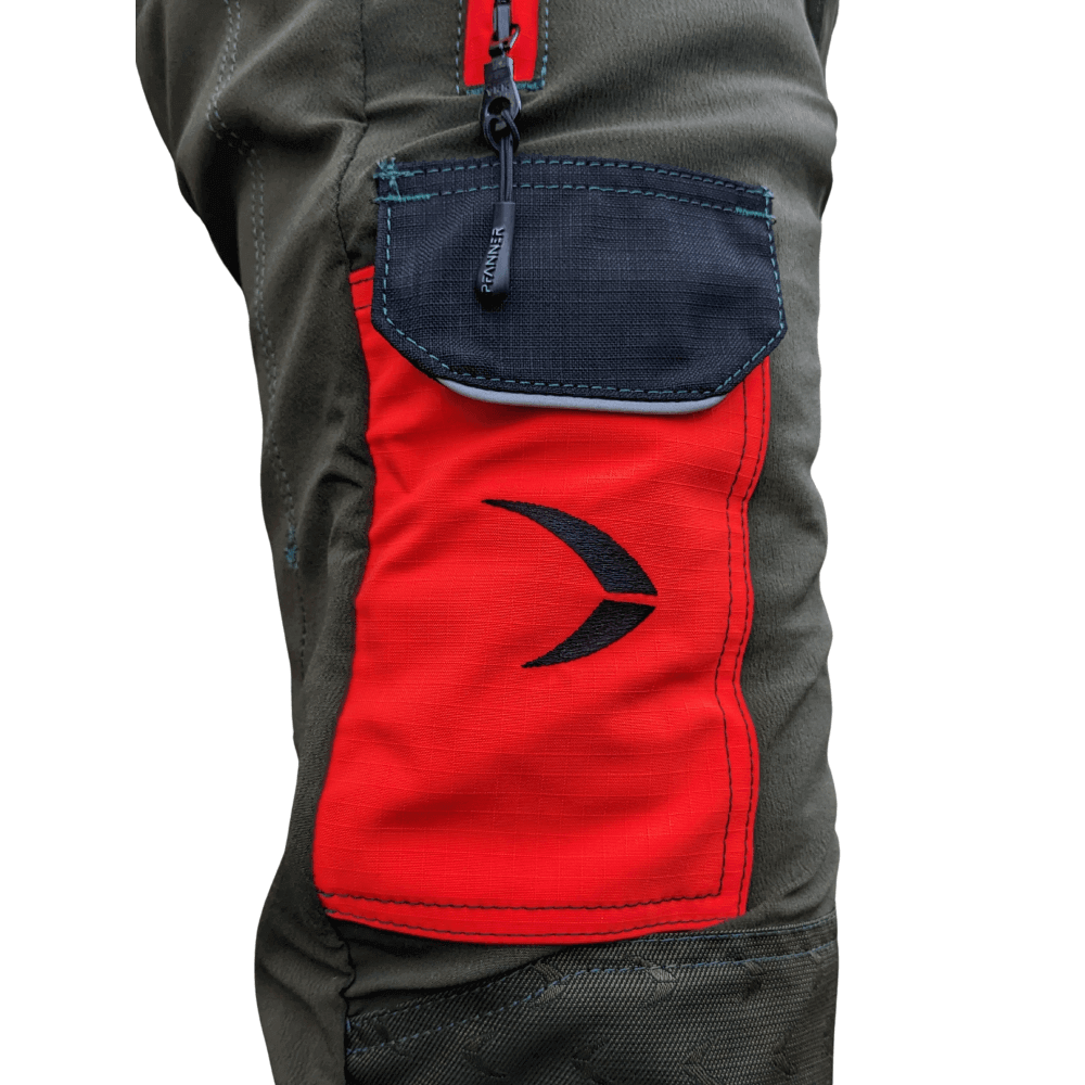 Close-up of Pfanner Arborist Chainsaw Trousers showing the red pocket design for tree surgeons.
