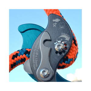 Close-up of the Akimbo Belay Device showing its friction mechanism and colorful ropes for climbing.