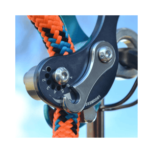 Close-up of the Rock Exotica Akimbo Belay Device showing the intricate friction mechanism and colorful ropes.