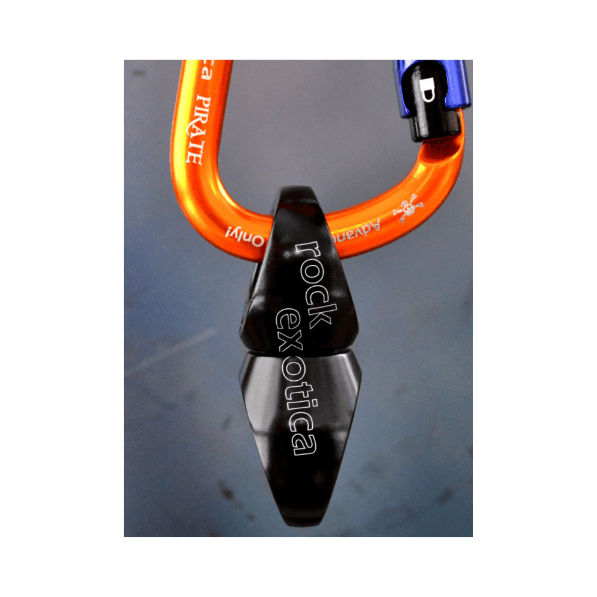 Rock Exotica Orbitor Swivel attached to an orange carabiner for rigging applications.