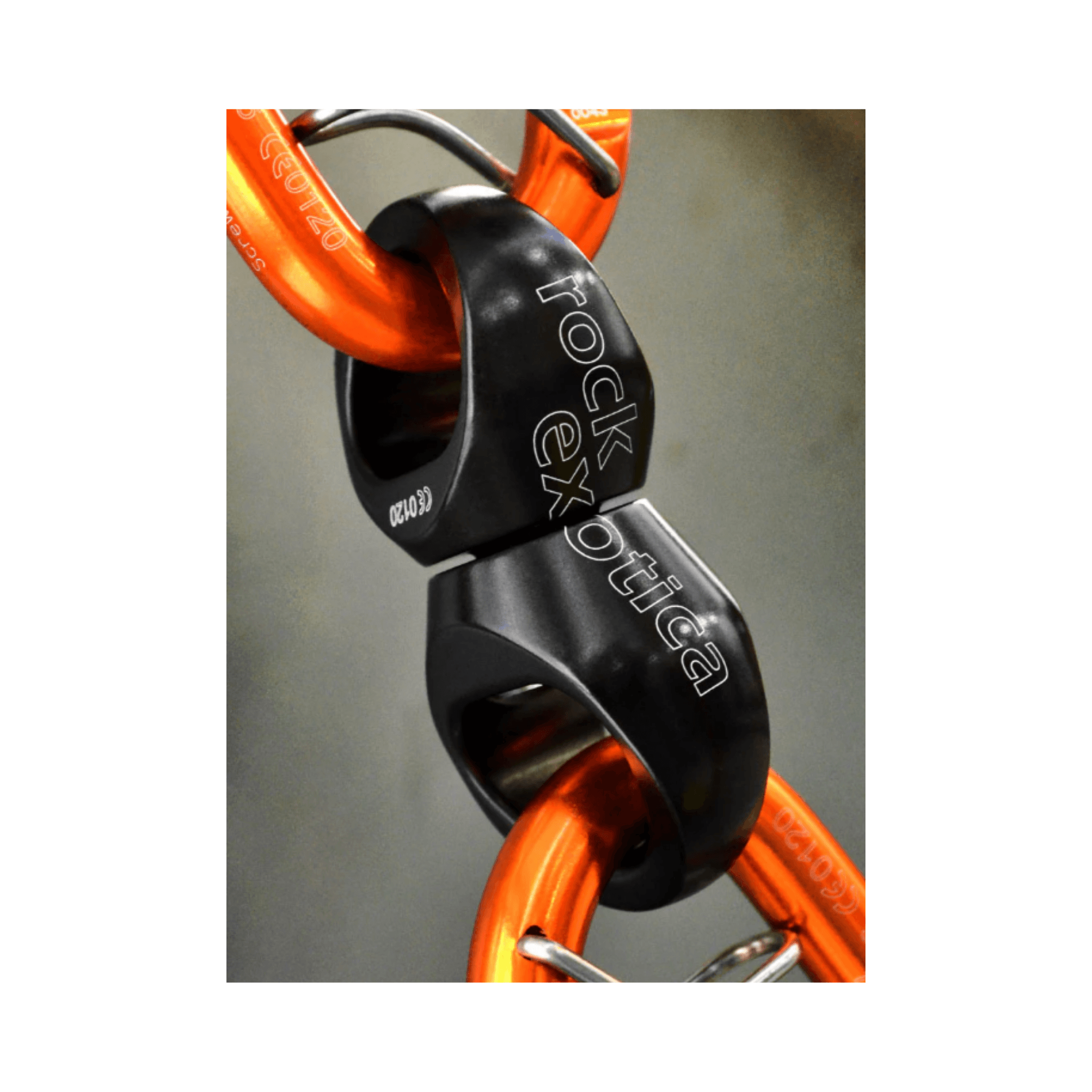 Close-up of Rock Exotica Orbitor Swivel showcasing its compact design and connection to orange rigging components.