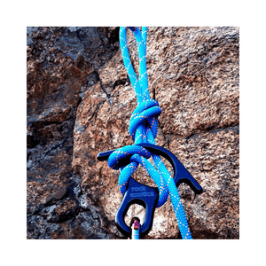 Rock Exotica Rescue Eight Descender with a blue climbing rope secured to a rock surface.