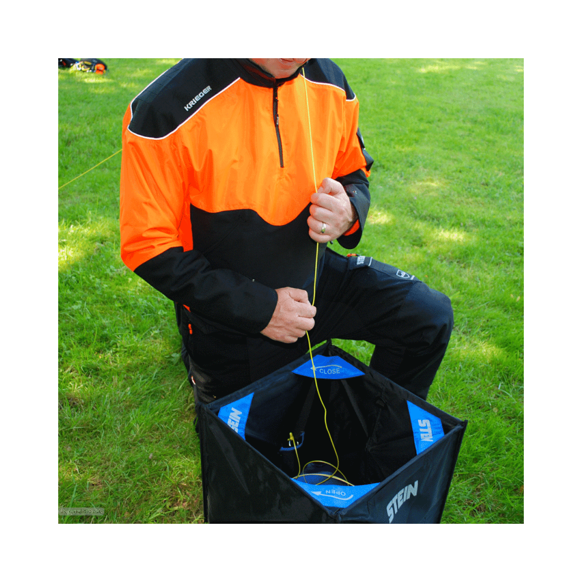 Tree surgeon using the Stein Cube Throwline Kit for safe climbing rope handling.