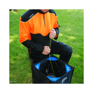 Tree surgeon using the Stein Cube Throwline Kit for safe climbing rope handling.